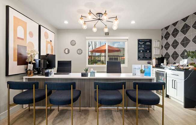 A modern kitchen with a bar area and chairs.