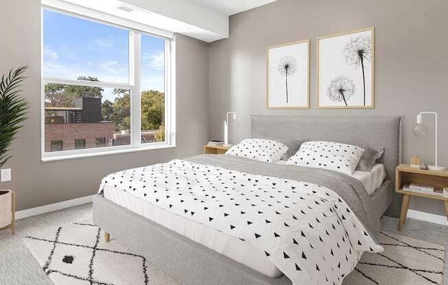 A bedroom with a large bed and a potted plant.