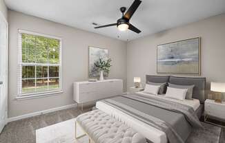 addison point interior staged model bedroom with a bed and a ceiling fan