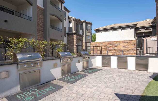 A BBQ zone is marked on the ground in front of apartment buildings.