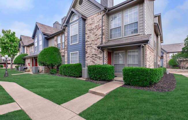 a large lawn in front of a brick building