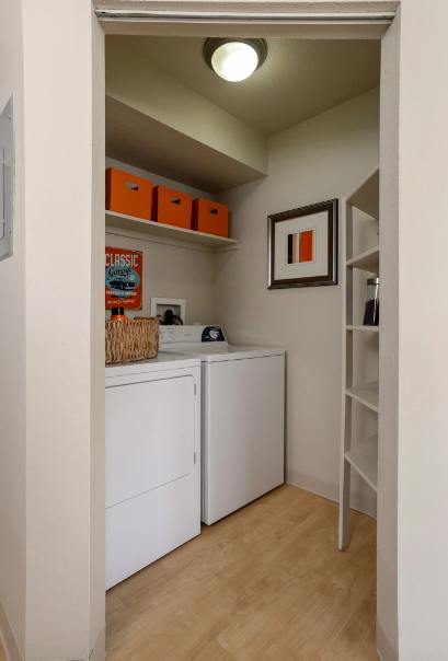 A small laundry room with a washer and dryer.