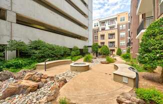 an outdoor area with benches and rocks and plants