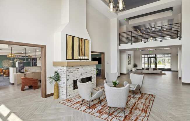 a living room with a fireplace and a staircase in the background