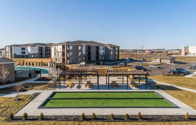 an aerial view of an apartment complex with a pool and grass at Echo Park at Perry Crossing Apartments, Plainfield, IN