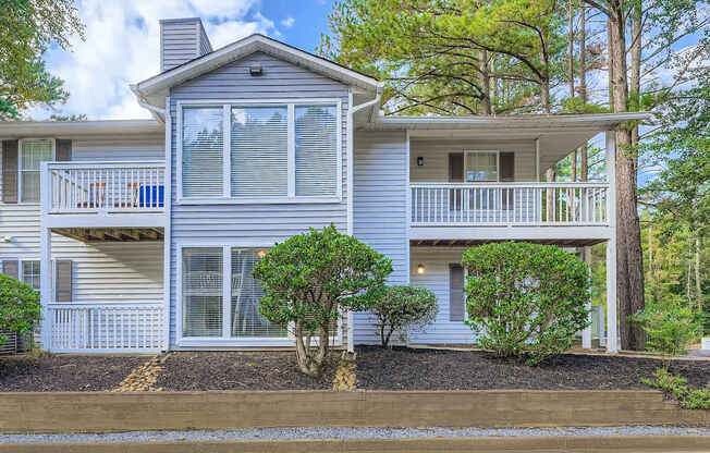A house with a grey exterior and a balcony.