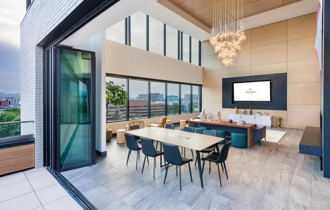 Host guests or unwind solo in the indoor-outdoor lounge with dramatic ceilings, city views, and comfortable seating areas.