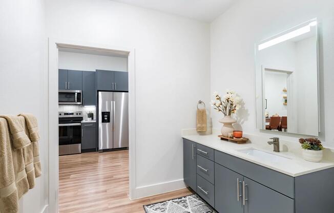 Elevate your daily routine in Modera Garden Oaks with designer bathrooms featuring sleek double vanities and elegant backlit mirrors. Your personal oasis awaits!