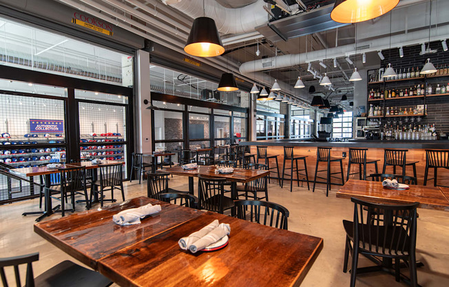 the interior of a restaurant with tables and chairs and a bar