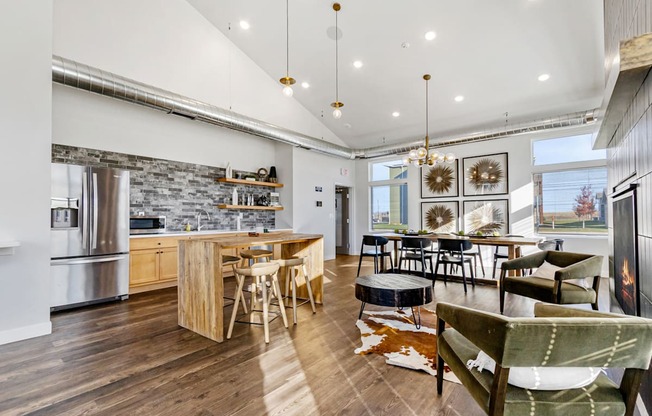 A modern kitchen with wooden floors and a stone backsplash.