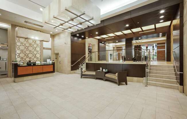 A reception area with a brown counter and a staircase.