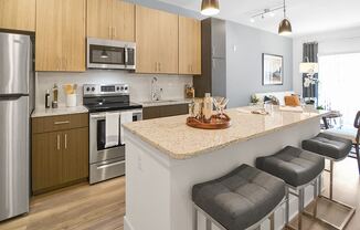 a kitchen with an island and stools in a house