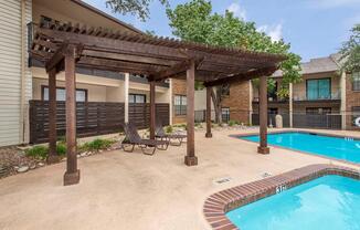 a house with a pool in front of a building