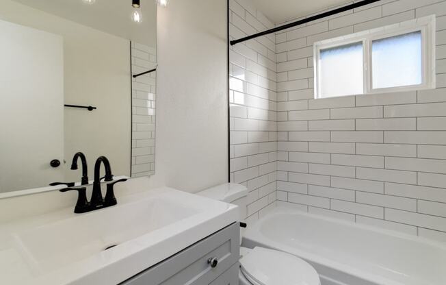 a bathroom with a sink and a toilet and a tub