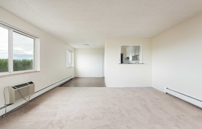 the living room of an empty house with a large window