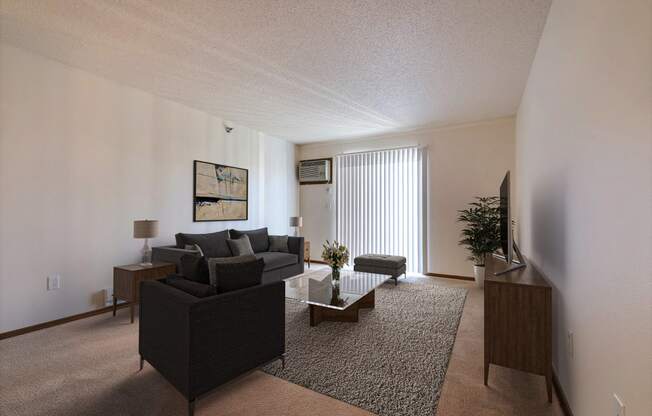 a living room with a couch and a coffee table. Fargo, ND Eagle Run Apartments