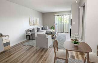 a living room with white walls and a wooden floor