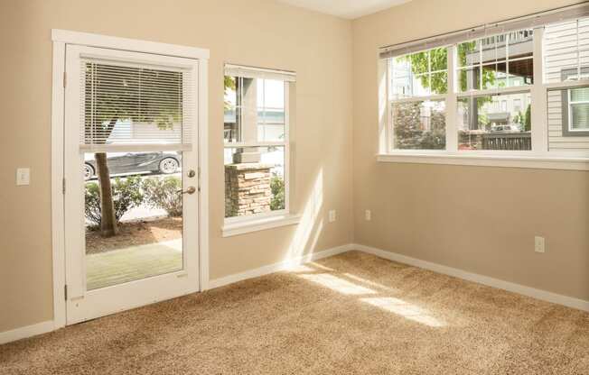 an empty living room with a door to a patio