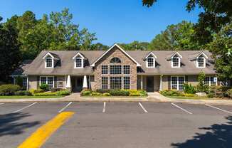 A building with a parking lot in front of it.
