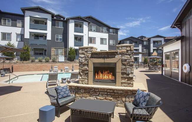 pool deck with fireplace and seating