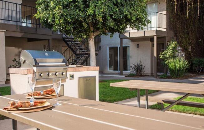 a grill and picnic table in a yard