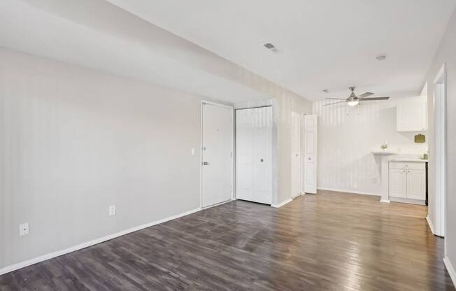 A room with a wooden floor and white walls.