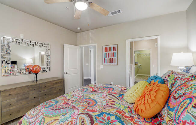 a bedroom with a bed and a ceiling fan