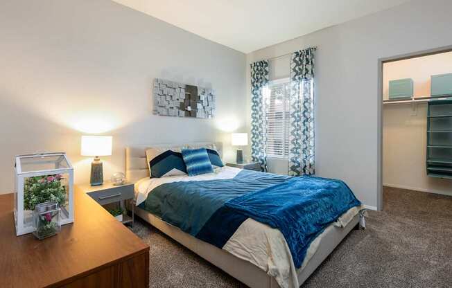 a bedroom with a bed and a dresser and a mirror