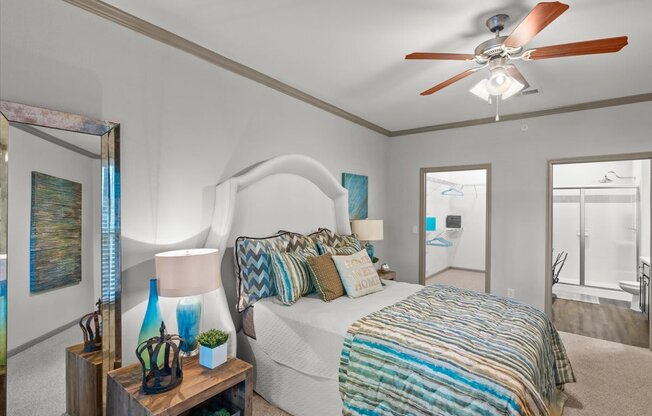 a bedroom with a bed and a ceiling fan