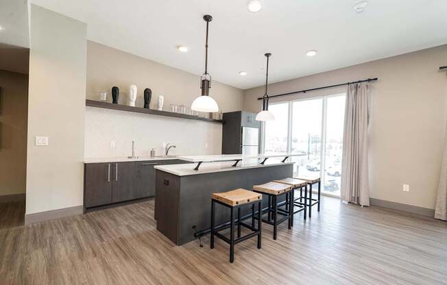 A modern kitchen with a large island and bar stools.