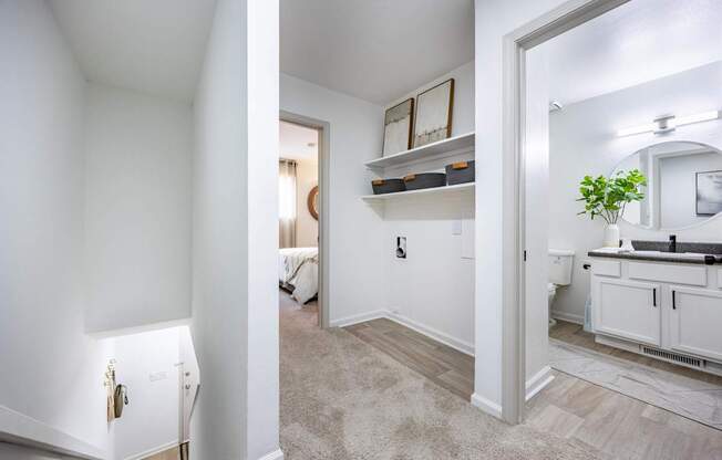 a living room and a bathroom with a sink and a mirror