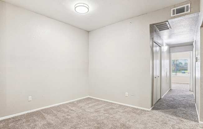 Large living room with an empty space for multiple usage at Laurels of Sendera apartments in Arlington, TX