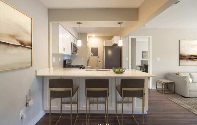 a kitchen with white cabinets and a large island with four stools