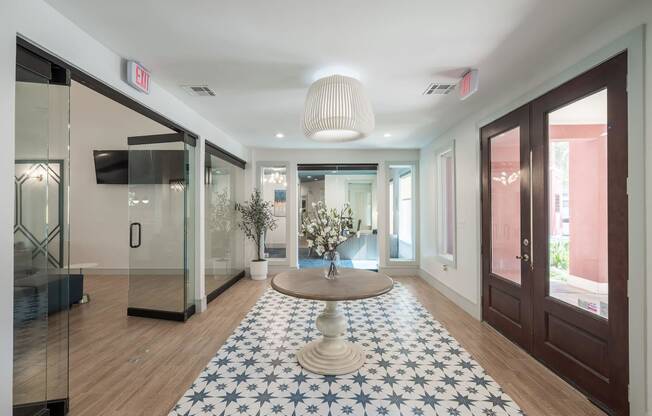 a lobby with a round table and a blue and white rug