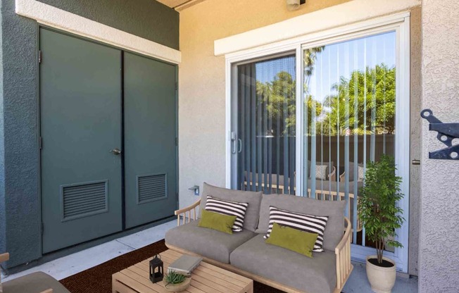 a patio with a couch and a patio door