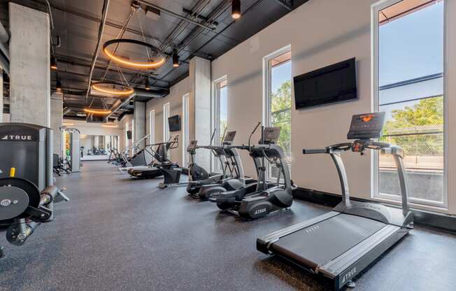 cardio equipment and a flat screen tv at TREO Apartments, Cleveland, 44116