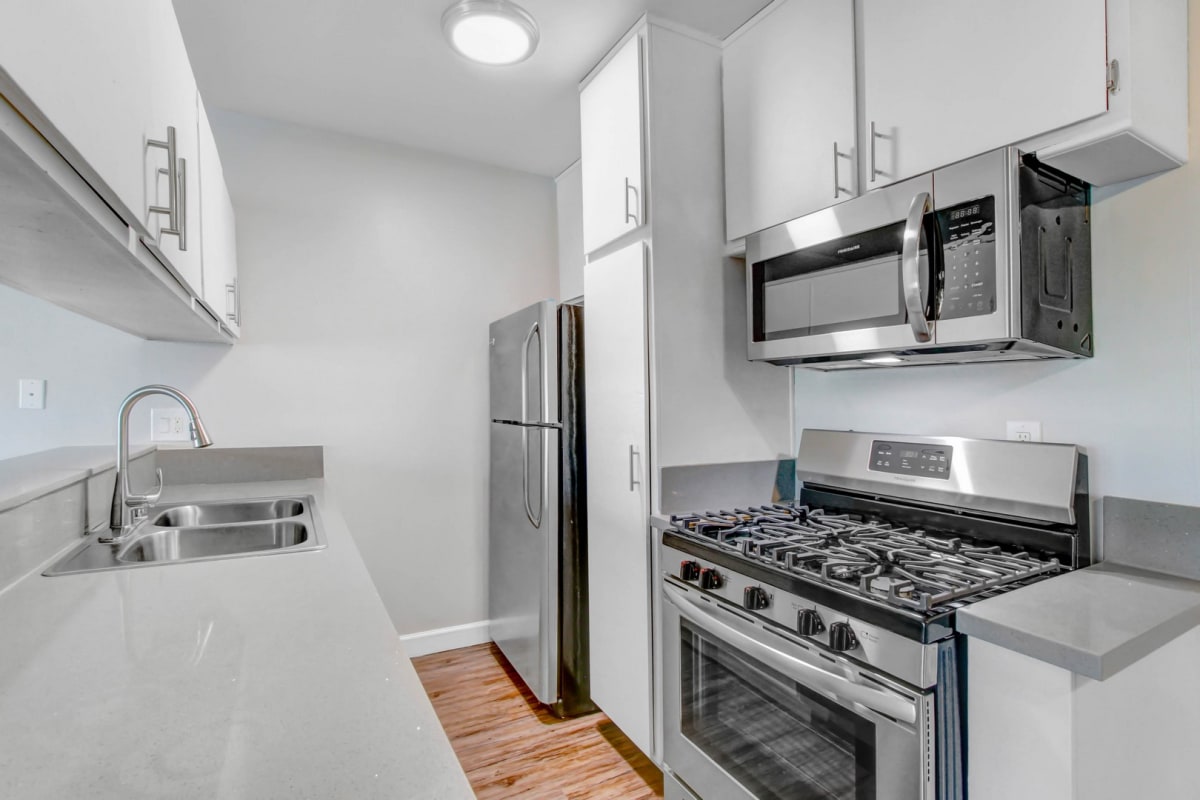 a kitchen with stainless steel appliances and white cabinets