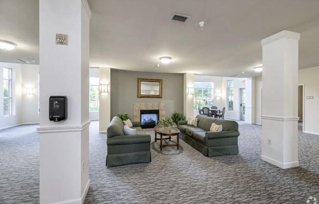 A living room with a fireplace and a painting on the wall.
