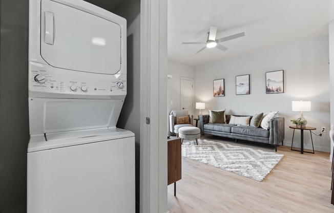 A white washing machine is in a laundry room.