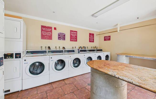 A row of washing machines in a public laundromat.