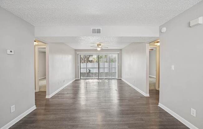 A long hallway with a door on the left and a door on the right.