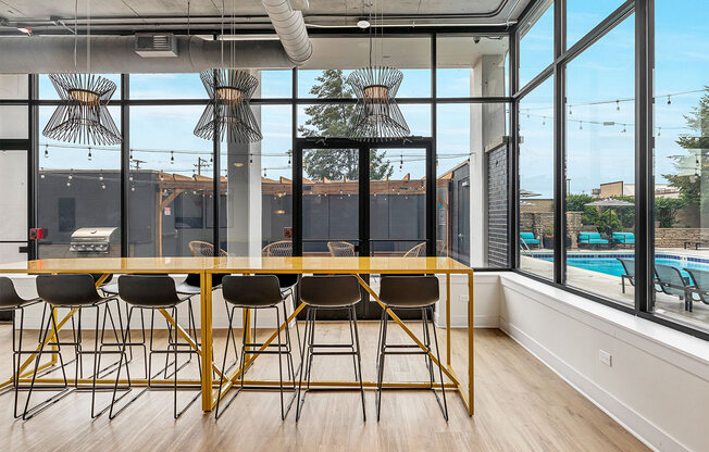 a dining room with a large window and a table with chairs