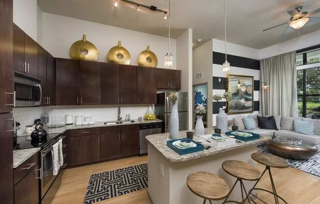 a kitchen and living room with a bar and stools