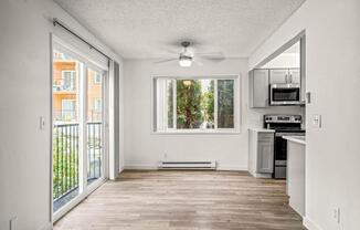 an empty kitchen and living room with a sliding glass door