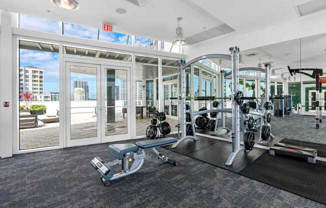A gym with a view of the city outside the windows.