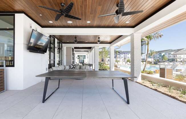 a ping pong table under ceiling fans at a relaxation deck at Lake Nona Concorde