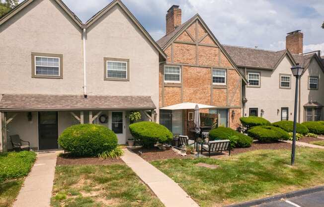 the view of the front of a house with a yard and a sidewalk