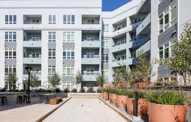 an outdoor courtyard in front of an apartment building