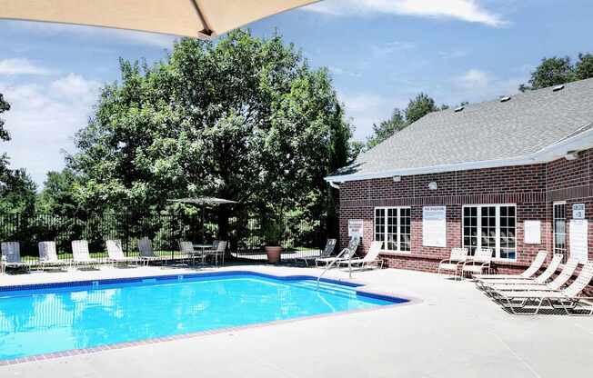 A pool surrounded by chairs at Tranquility Pointe, Omaha, Nebraska