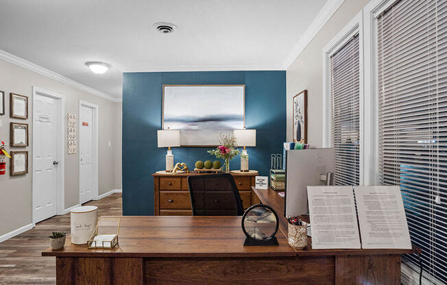 a office with a desk and a painting on the wall